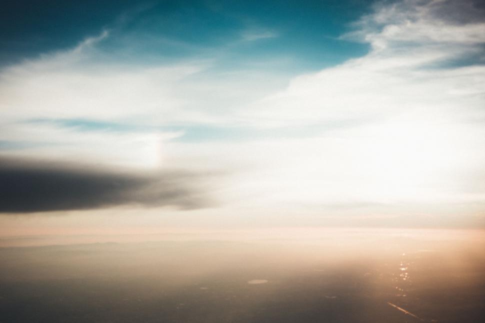 Free Image of Majestic aerial view of sky with clouds at sunset time. 