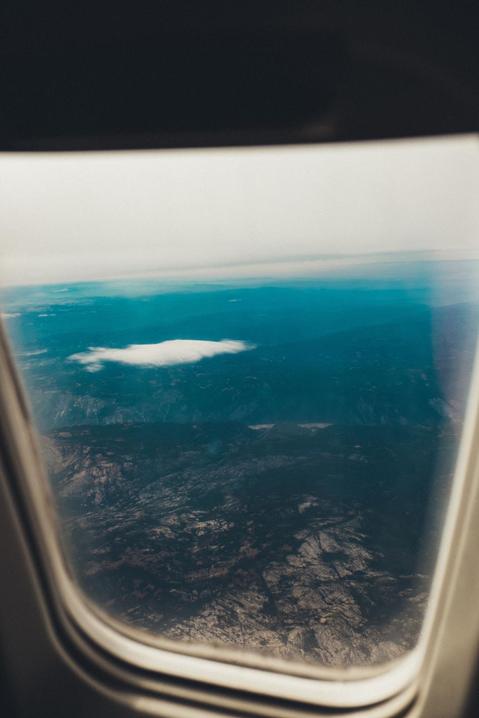 Free Image of Captivating view out of airplane window over mountain range. 