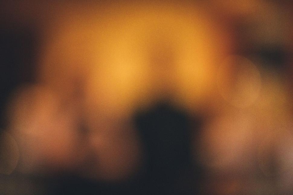 Free Image of Abstract blurred image with warm golden tones and lights. 