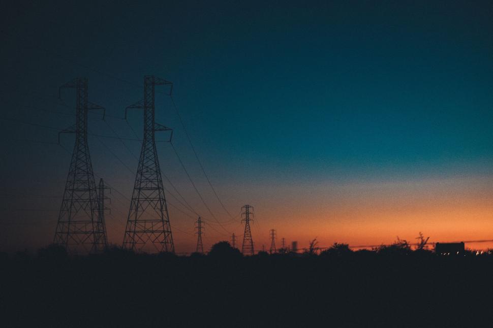 Free Image of Silhouetted power lines against a twilight sunset sky. 