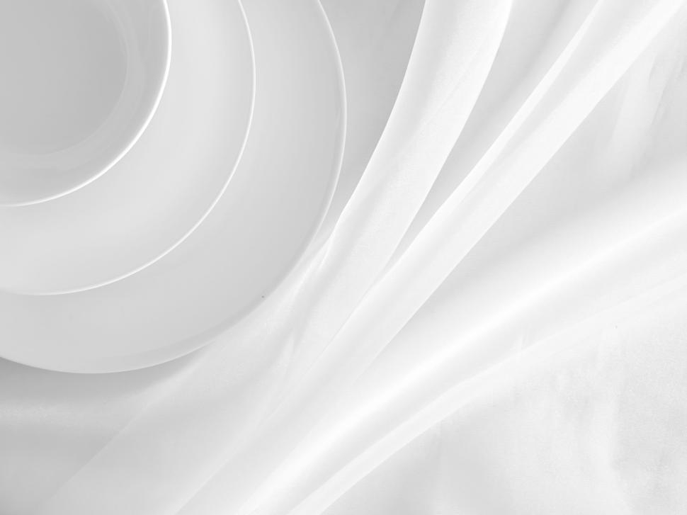 Free Image of White plates with soft cloth backdrop minimalist style. 
