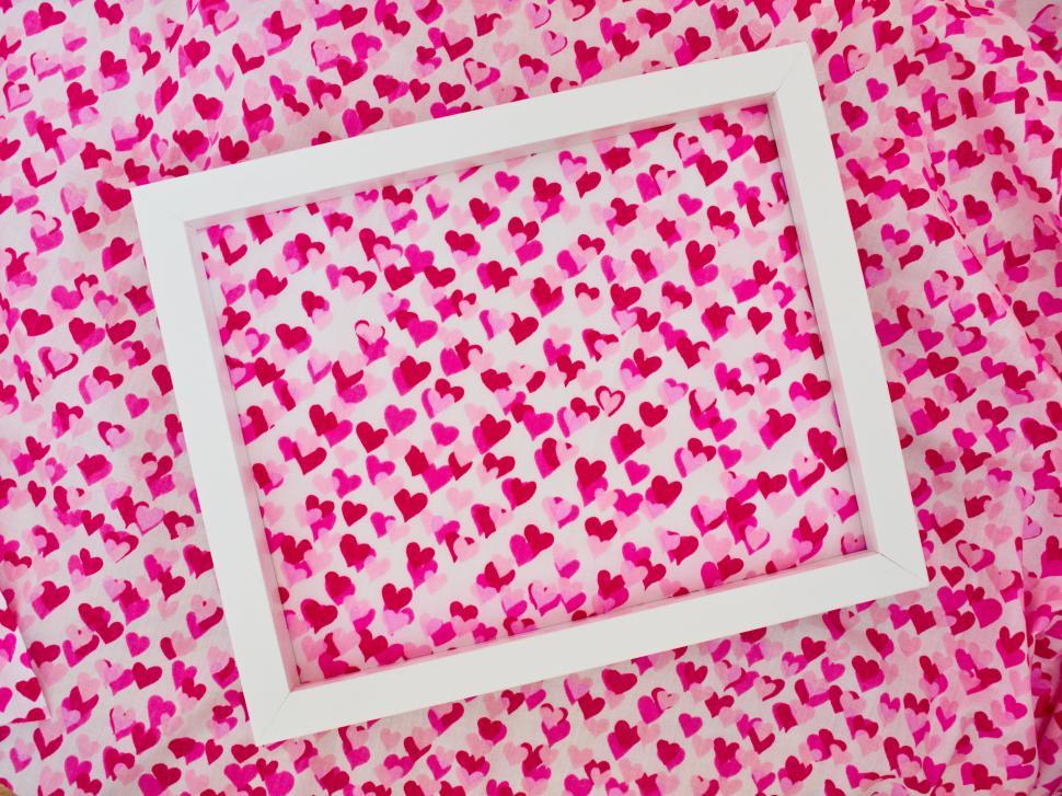Free Image of Bright pink hearts background with white rectangle frame. 