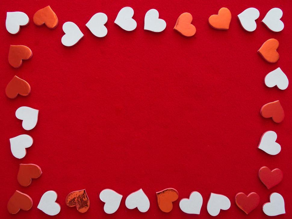 Free Image of Frame of white and red hearts on vibrant red background 
