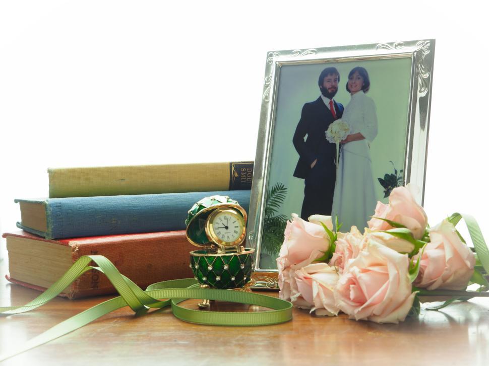 Free Image of Vintage wedding photo with roses and old books on table. 