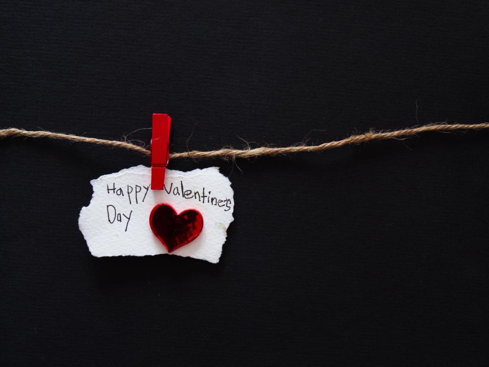 Free Image of Happy Valentine s Day note with red heart on black background 