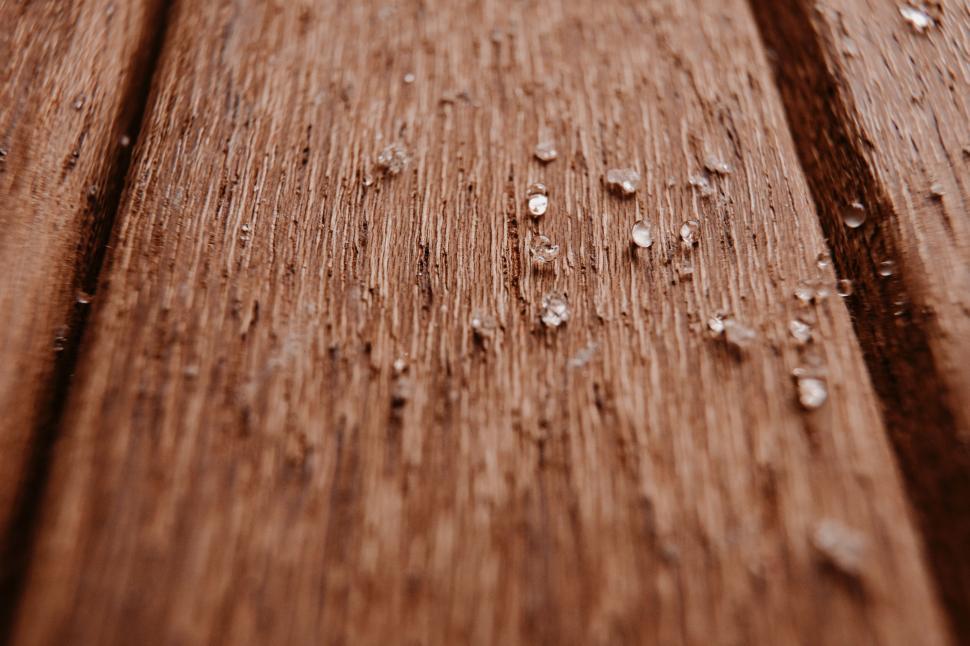 Free Image of Close-up of wet wooden surface with water drops 