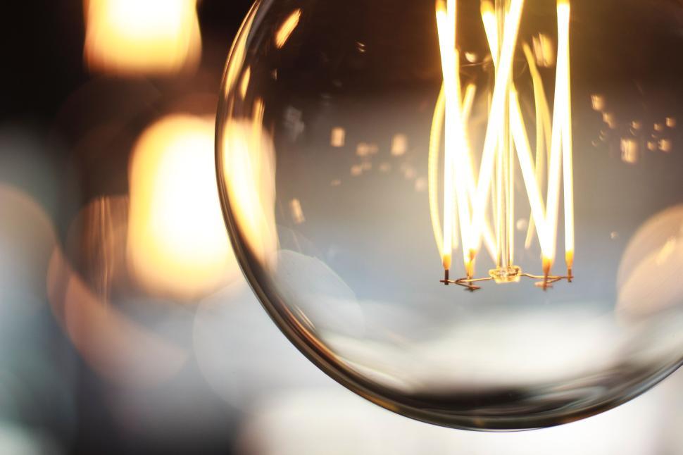 Free Image of Close-up of a glowing light bulb filament shining brightly. 