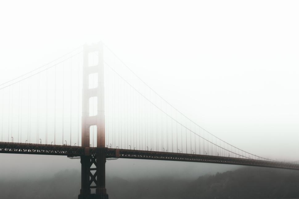 Free Image of Golden Gate Bridge emerging from mist on a foggy day. 