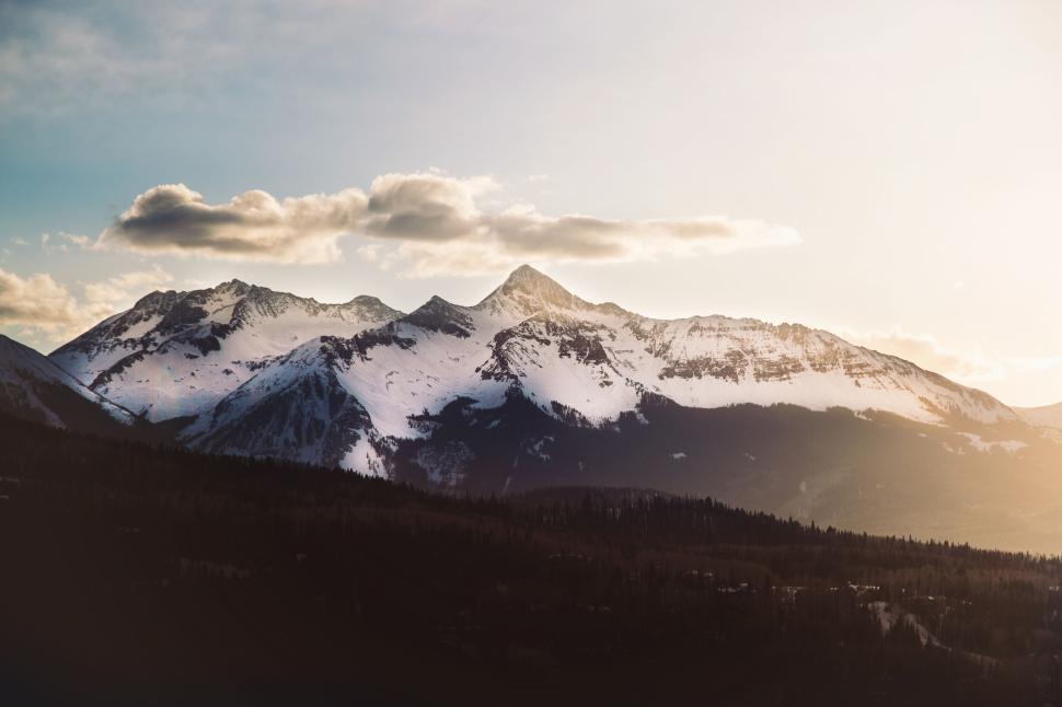 Free Image of Snowcapped mountains under a clear blue sky at sunset 