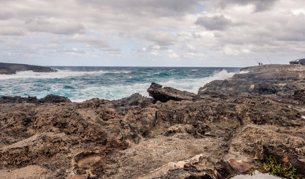 Free Image of Crashing ocean waves against rugged shoreline cliffs 