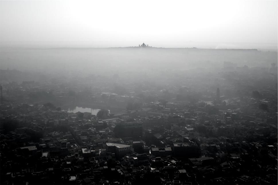Free Image of Foggy cityscape with smog and distant structures visible. 