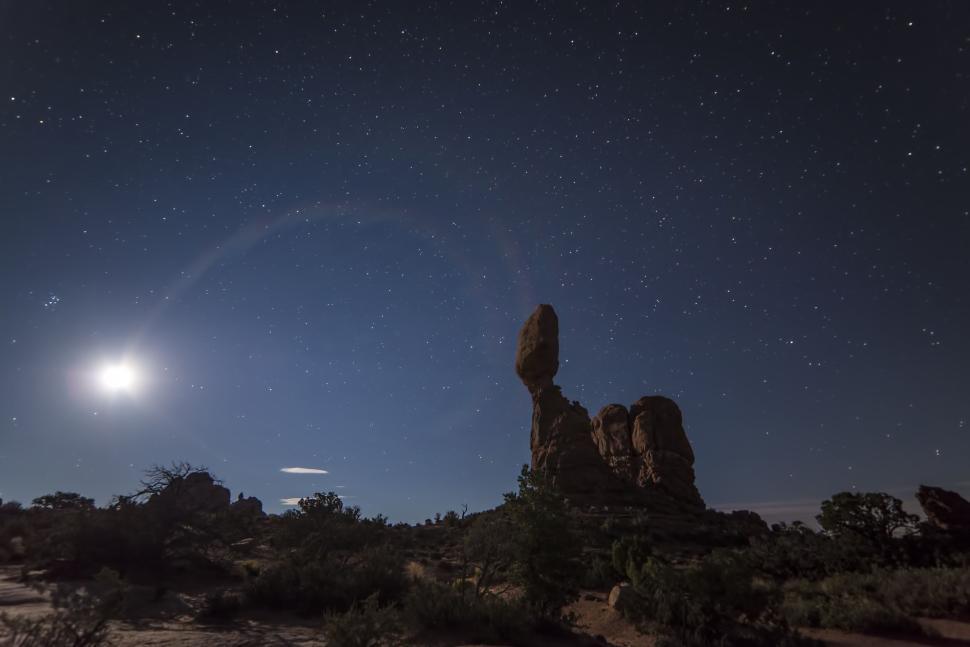 Free Image of Balanced rock formation under a star-lit night sky. 