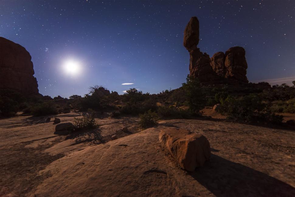 Free Image of Moonlit desert landscape with rock formations at night 