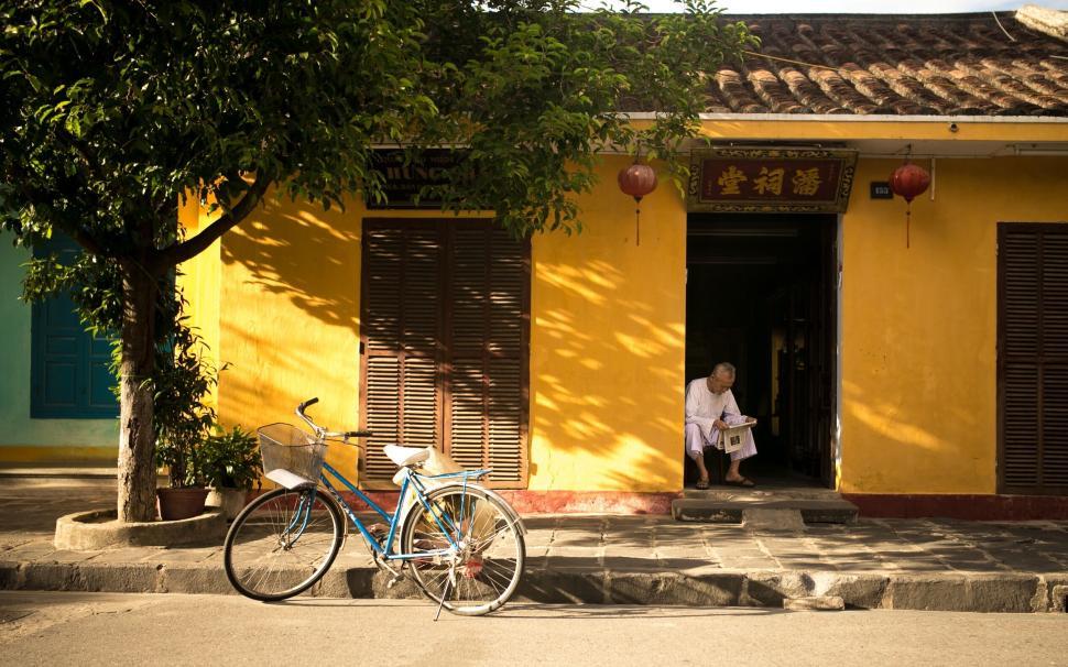 Free Image of Golden Hour View of a Yellow Building with Bicycle 