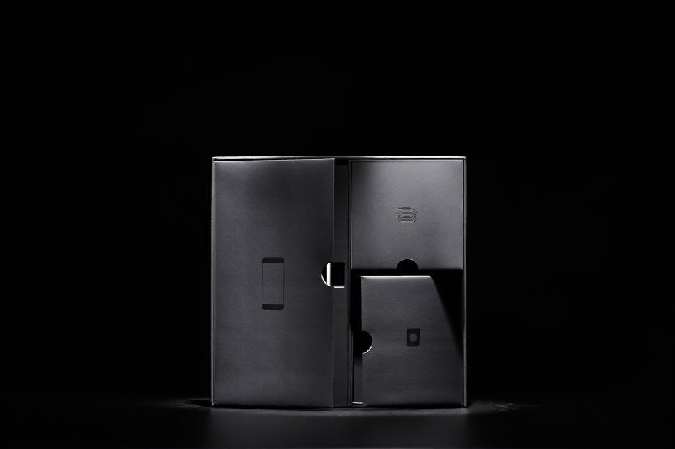 Free Image of Open black packaging box with multiple compartments. 