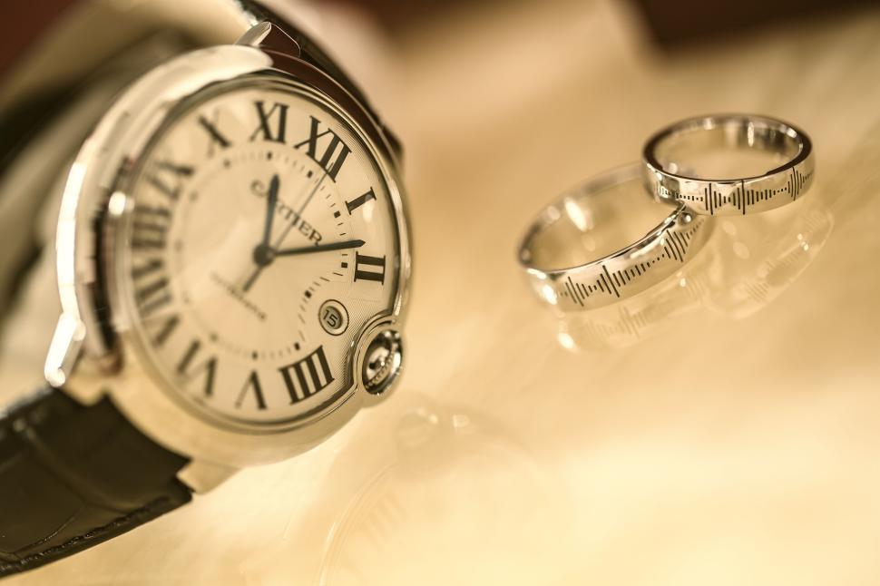 Free Image of Luxury watch and wedding rings on marble surface 