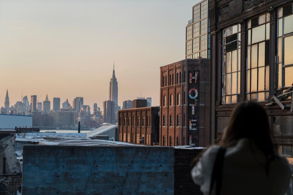 Free Image of City skyline through industrial buildings at sunset view. 