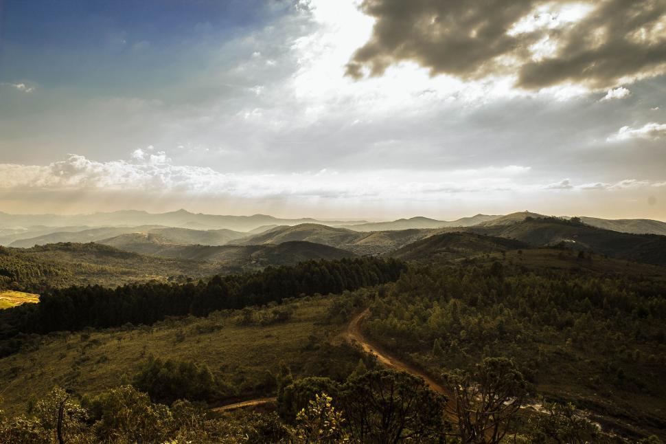 Free Image of Panoramic view of hilly landscape under a vast sky. 