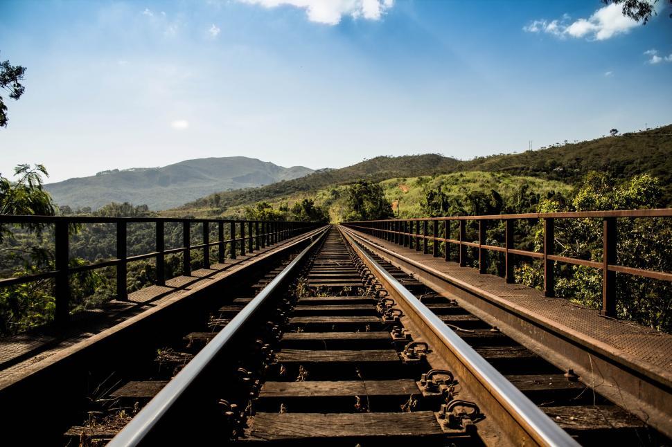 Free Image of Railroad tracks stretching into the distance with hills. 
