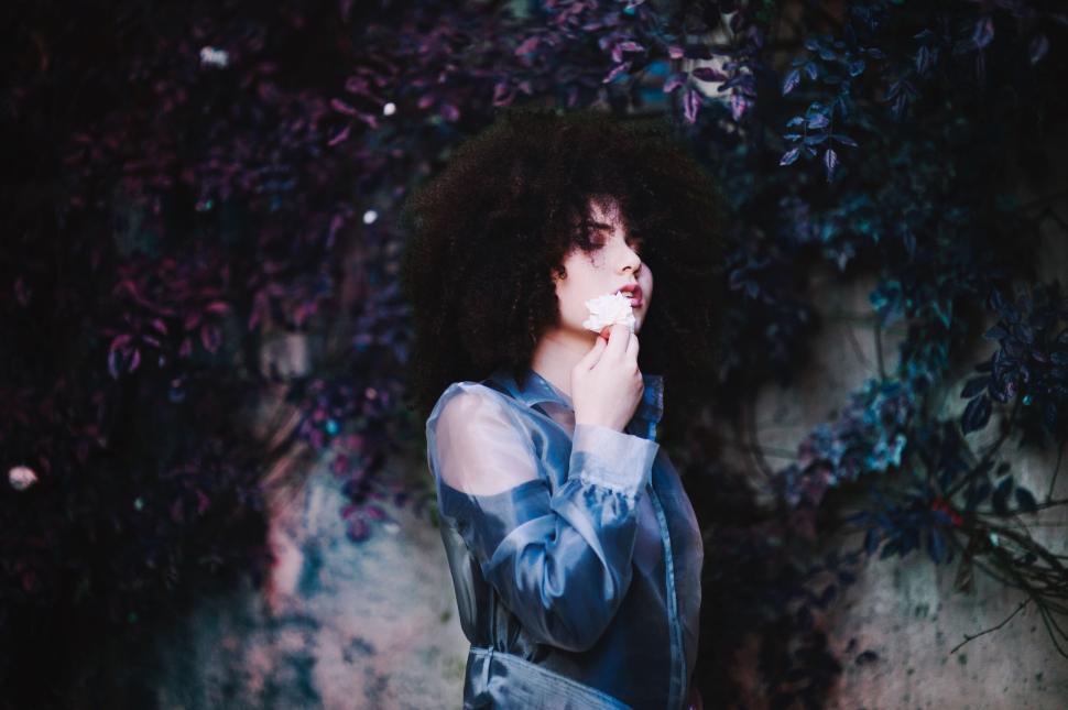 Free Image of Person standing in front of vibrant purple foliage. 