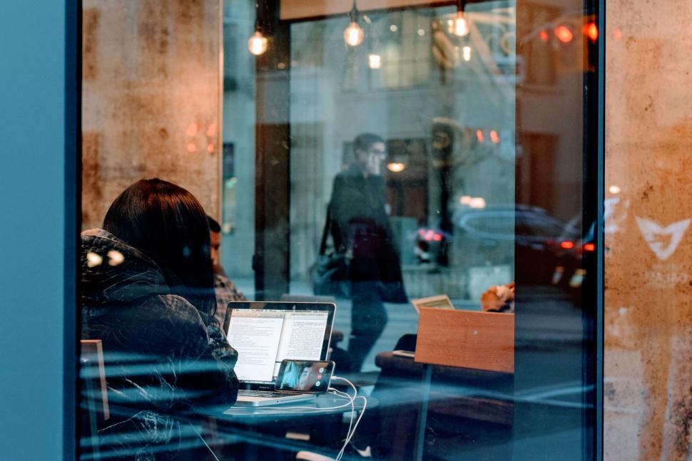Free Image of People working and relaxing in a cozy urban cafe 