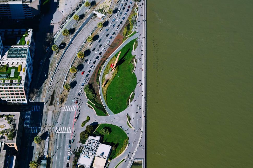 Free Image of Aerial view of waterfront park with curved pathways. 