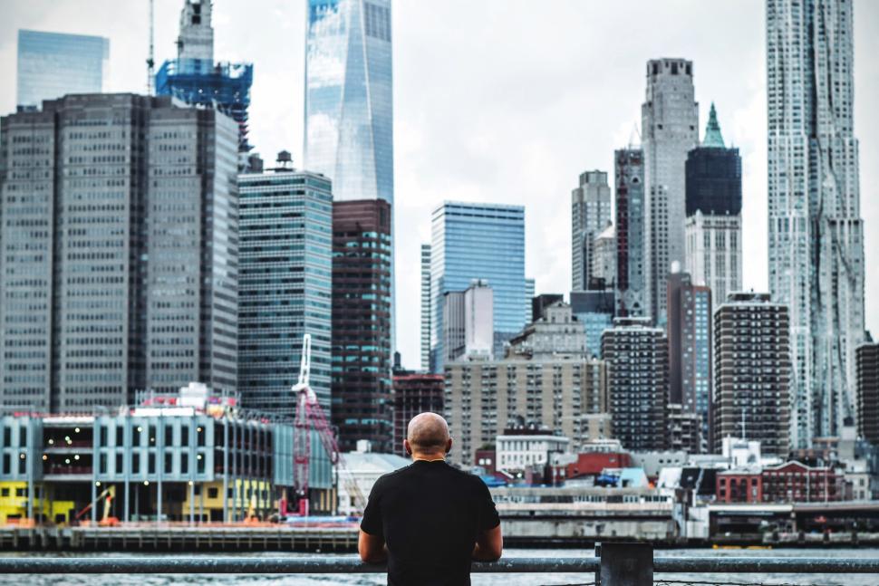 Free Image of Person overlooking city skyline with modern skyscrapers. 