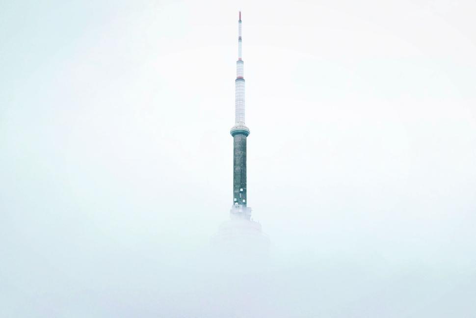 Free Image of Foggy image of iconic tower reaching above thick fog 