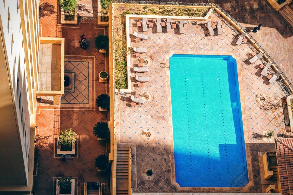 Free Image of Aerial view of a swimming pool in a residential area 