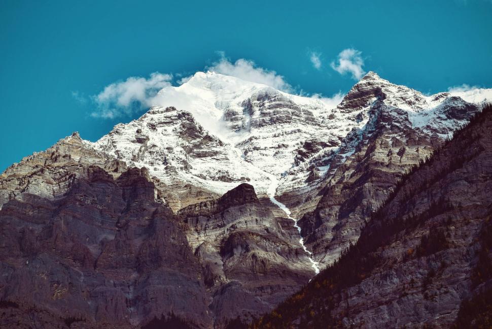 Free Image of Snow-covered mountain with clear blue sky background 