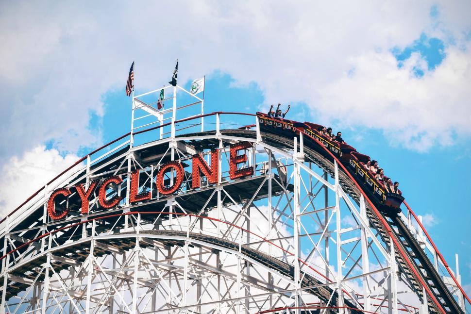 Free Image of Roller coaster named Cyclone with people riding it 