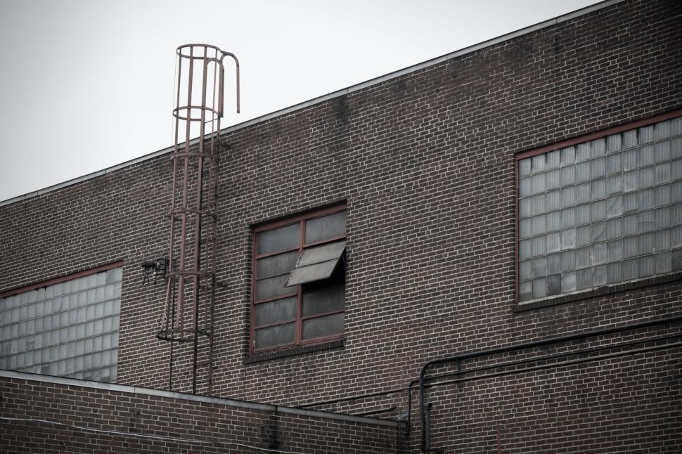 Free Image of Industrial building with exterior metal ladder structure 