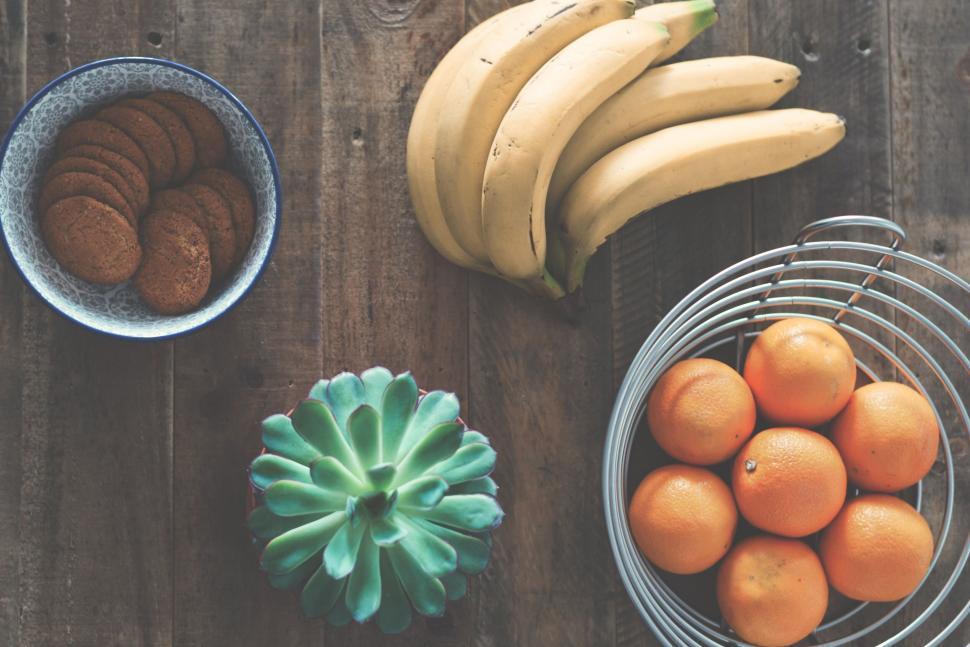 Free Image of Top view of fresh fruits, cookies, and a cactus display. 