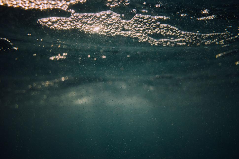 Free Image of Bubbles rising in a green underwater scene with sunlight 