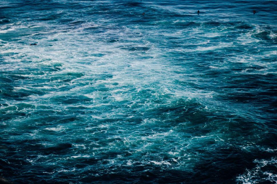 Free Image of Aerial view of ocean waves with a hint of surfers 