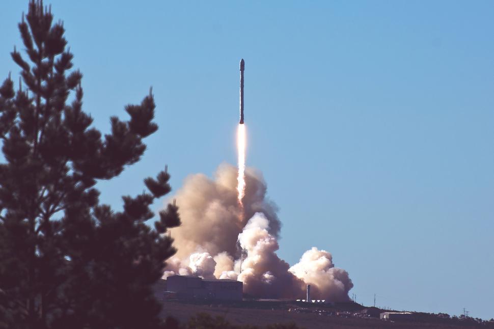 Free Image of Rocket launch with dense smoke trails in clear sky. 