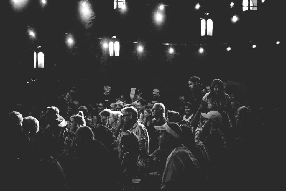 Free Image of Evening event with numerous attendees under string lights. 
