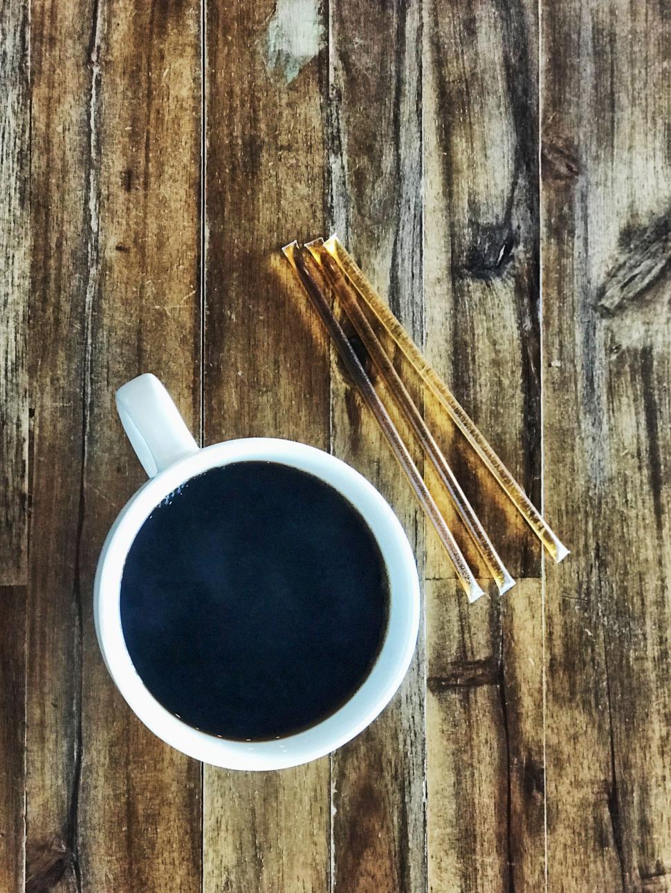 Free Image of White cup of black coffee on a rustic wooden table surface 