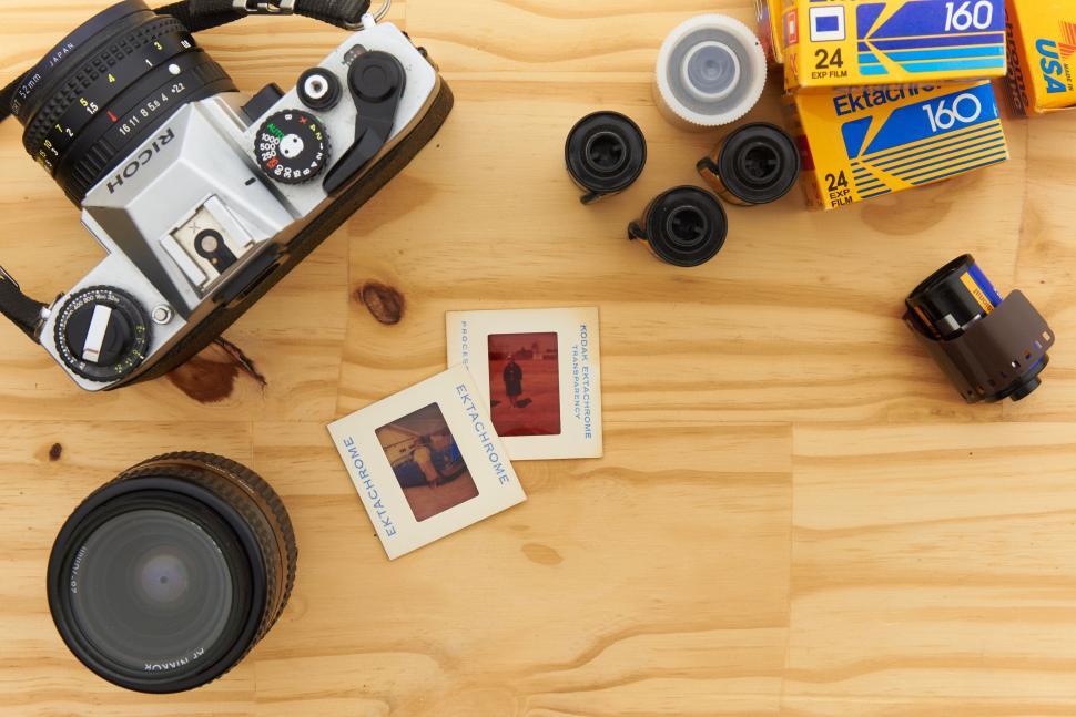 Free Image of Vintage camera with film rolls and printed photographs 