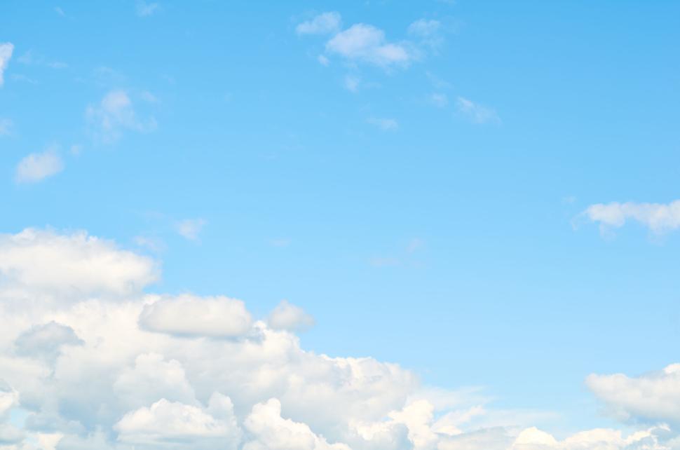 Free Image of Bright blue sky with fluffy white clouds floating high. 