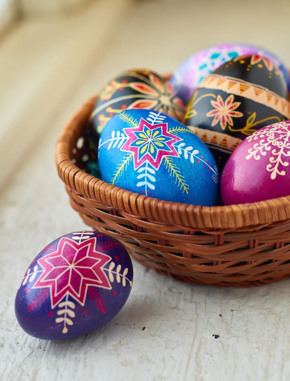 Free Image of Decorated Easter eggs in a wicker basket on the table 