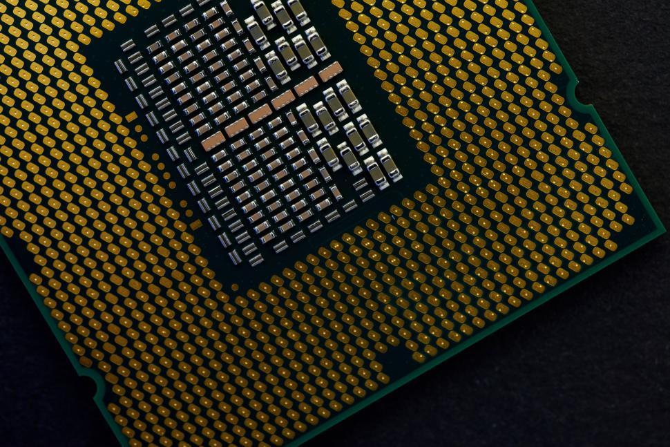 Free Image of Close-up of electronic microchip with detailed patterns. 