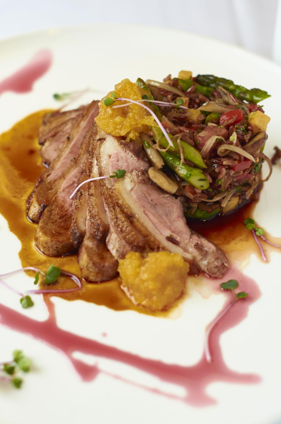 Free Image of Gourmet dish with meat, vegetables, and sauce details 