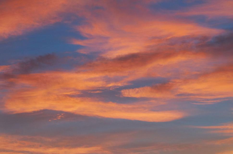 Free Image of Dramatic sunset with vibrant orange and pink clouds. 
