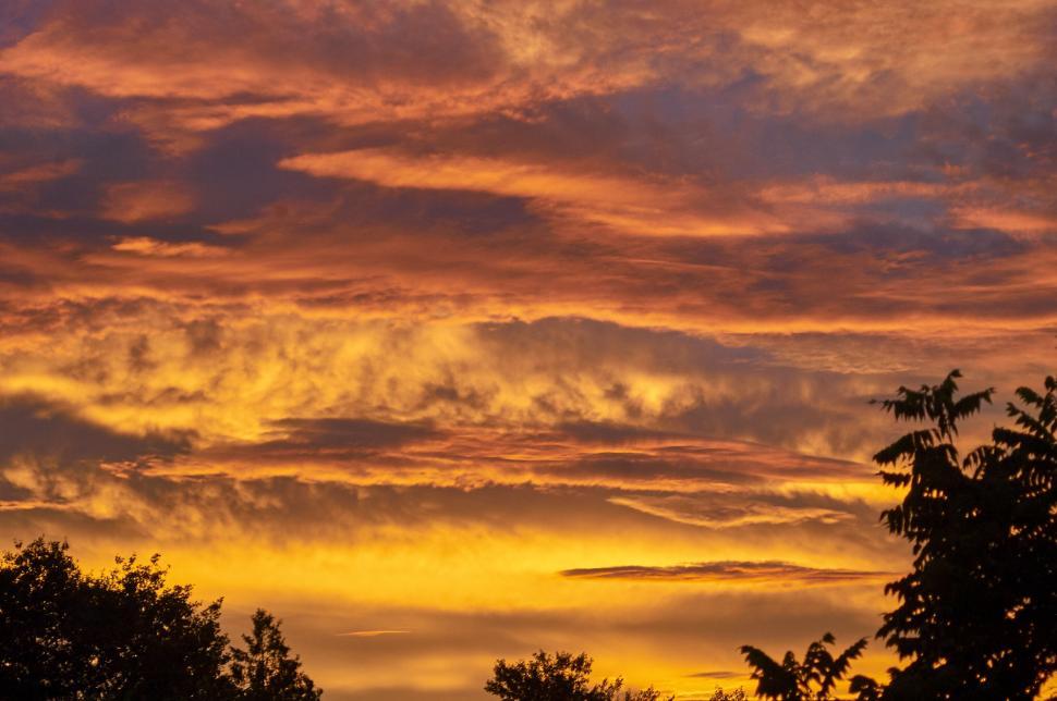 Free Image of Dramatic orange and red clouds blanketing sunset sky 