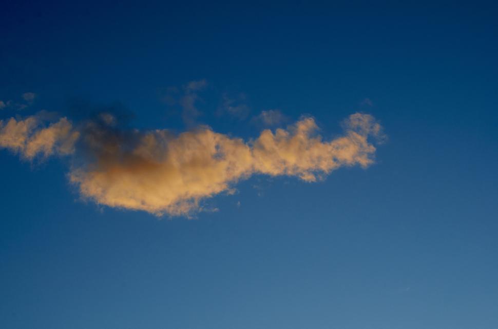 Free Image of Golden cloud in blue sky during serene sunset time 