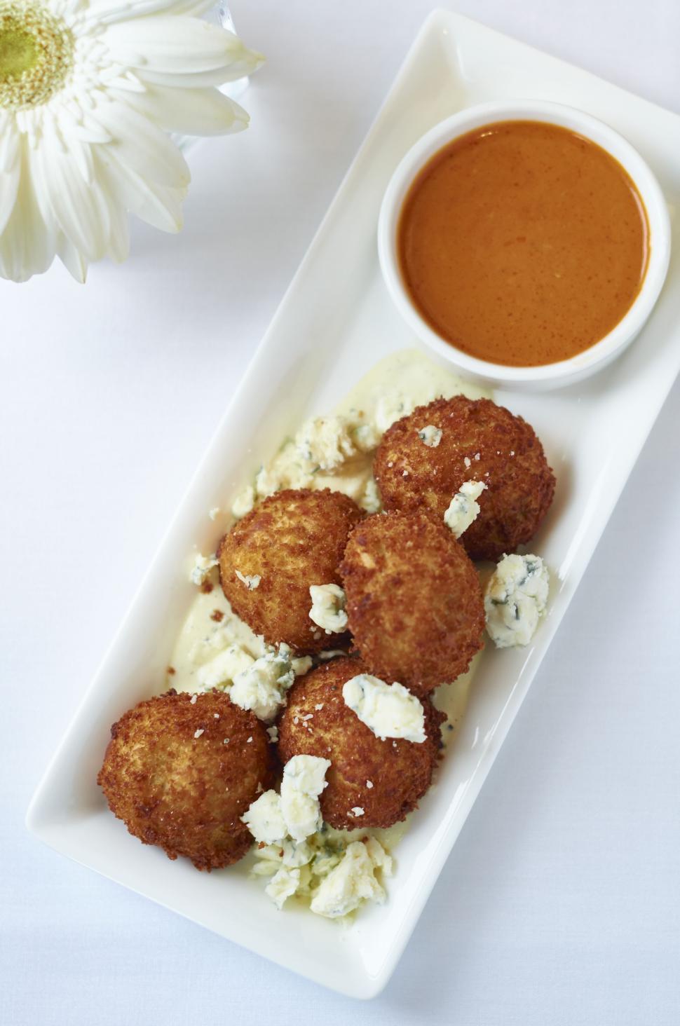Free Image of Crispy fried cheese balls with sauce on white plate 