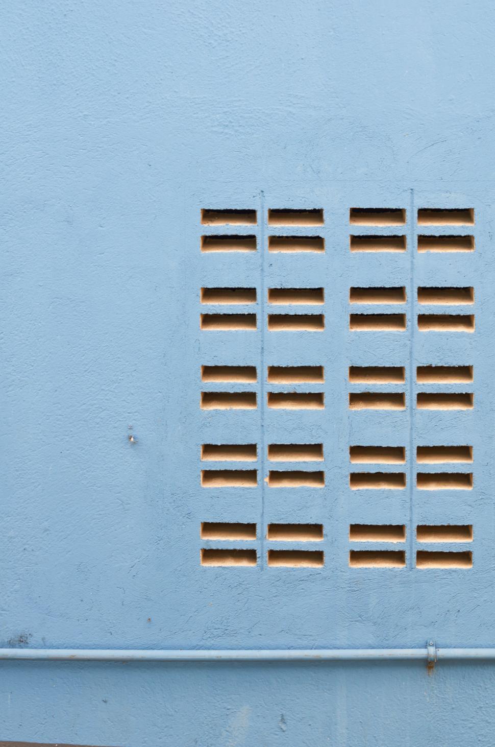 Free Image of Ventilation grid on a blue wall in an urban setting 
