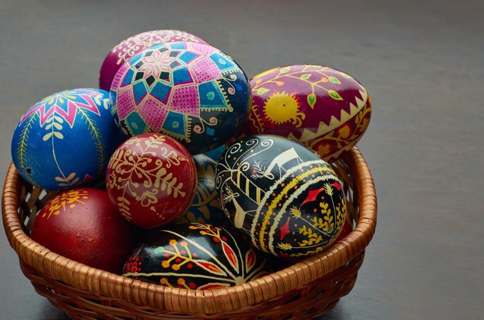 Free Image of Colorful Easter eggs in a wicker basket on a table 