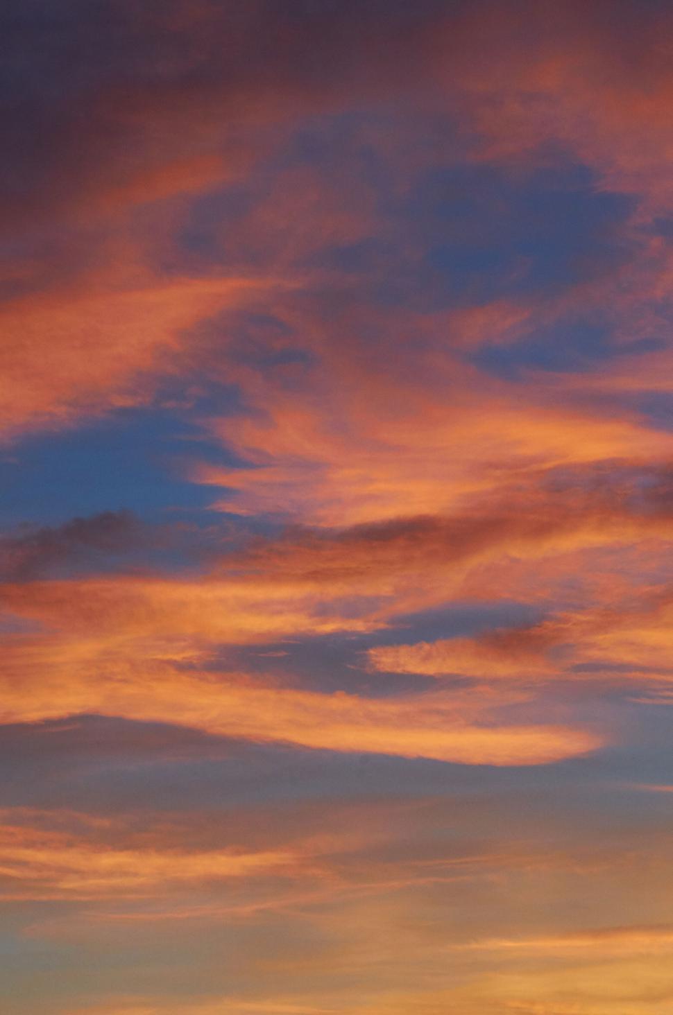 Free Image of Sunset hues in the sky with vibrant, colorful clouds. 